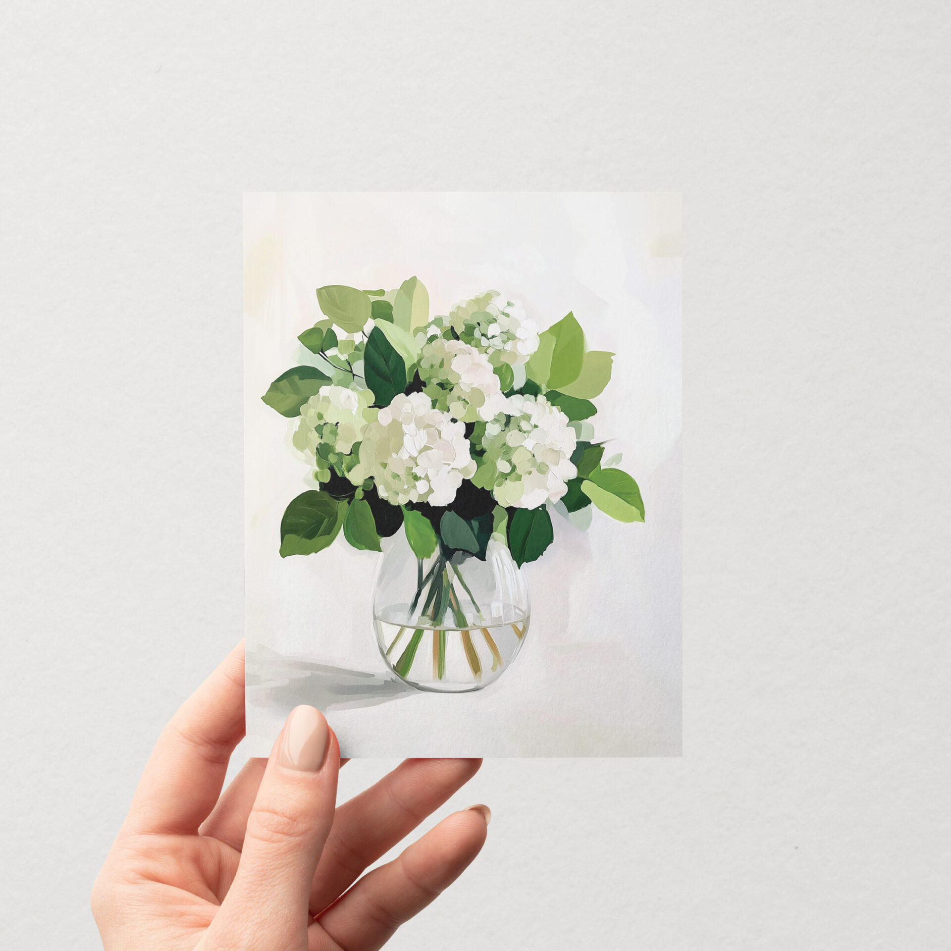 Carte de souhait illustrée « Hortensias blancs » de Mimosa Design, représentant un bouquet d'hortensias blancs dans un vase en verre, tenue à la main.