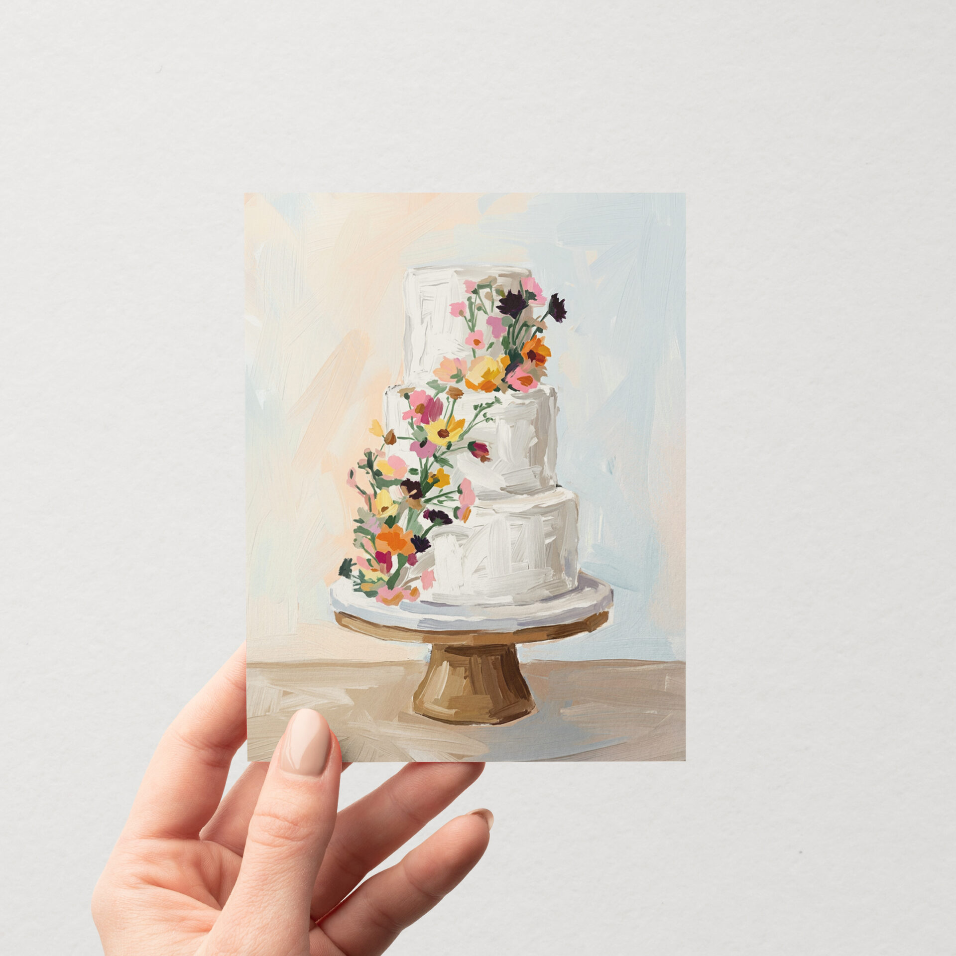 Carte de souhait illustrée « Gâteau fleuri » de Mimosa Design, représentant un gâteau de mariage à quatre étages décoré de fleurs sauvages colorées, tenue à la main.