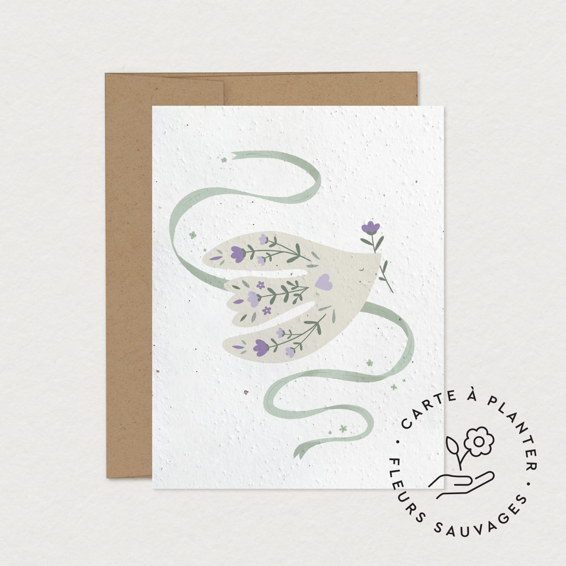 Carte à planter Envolée sur papier ensemencé illustrée d'une main ornée de fleurs sauvages et d'un ruban vert, création Mimosa Design.